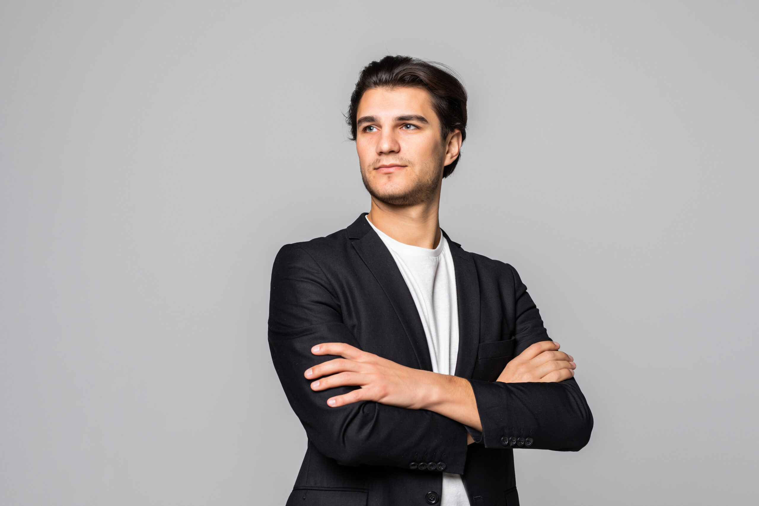smiling businessman standing with arms folded isolated white scaled